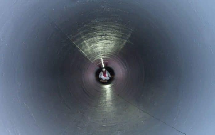 Man Working inside Pipe