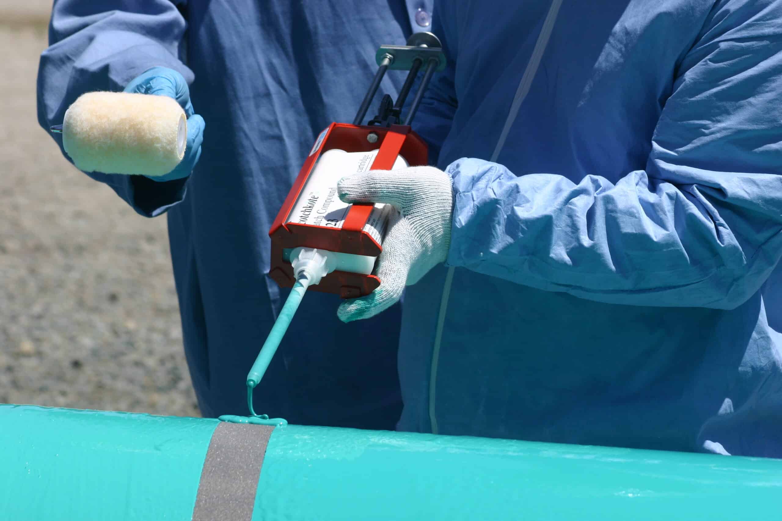Pipeline coating being applied to protect an industrial pipe from corrosion